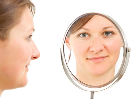 young woman's  isolated portrait reflecting froma  bathroom mirrorの写真素材