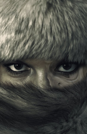 A portrait of an attractive woman wearing a fur hat with the design of the skull on her faceの写真素材