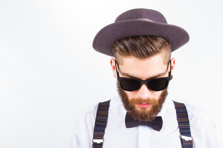 young hipster man wearing  hat and bow-tieの写真素材