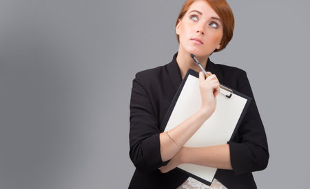 young red-haired  secretary with a blank folderの写真素材