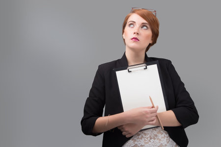 young red-haired  secretary with a blank folderの写真素材