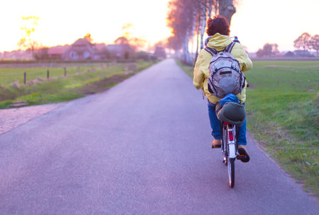 Man with backpack traveling by bicycle.の写真素材