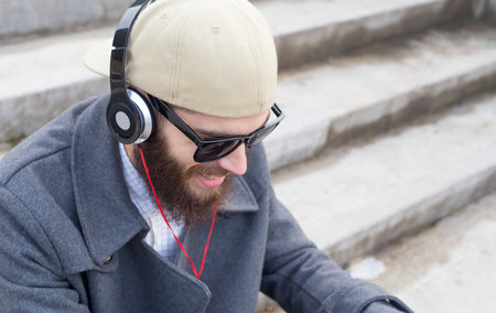 Handsome guy listening to music with heatset.の写真素材
