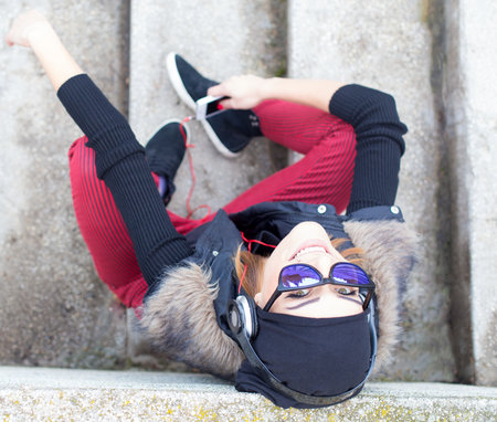 Gorgeously smiling woman listening to music.の写真素材