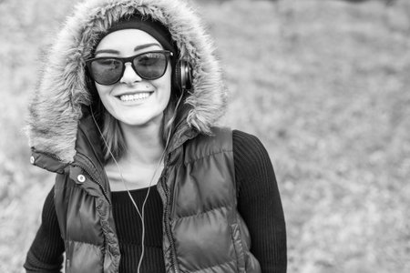 Beautiful woman listening to music with earphones.の写真素材