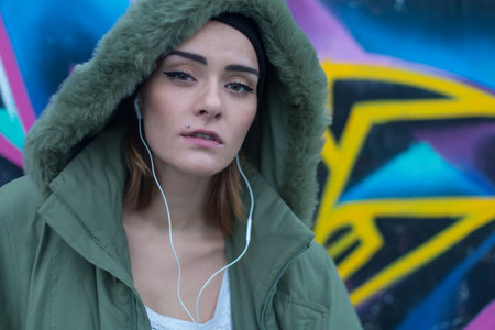 Beautiful girl listening to music with handsfree.の写真素材