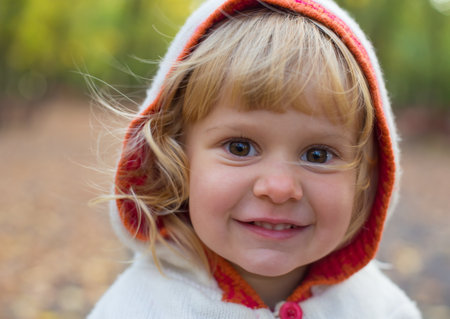 Portrait of a beautiful little lady in her cute hoodie outdoors.