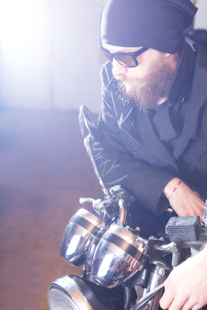 Portrait of a man and his chopper motorcycle.