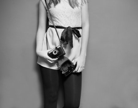 Stylish female photographer with old camera - black and white image.の写真素材