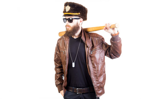Stylish hipster looking like an officer with cap and bat.の写真素材