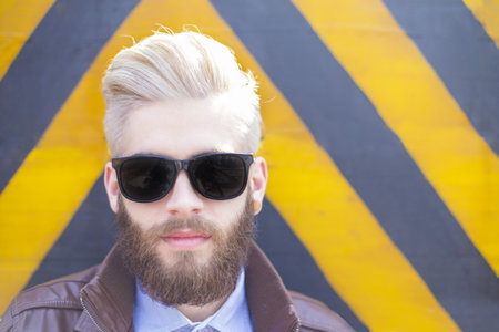 Hipster guy showing how to wear beard, hair and glasses with genuine style.の写真素材