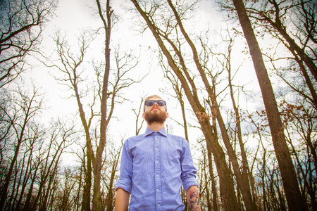 Hipster guy showing how to wear beard, hair and glasses with genuine style.