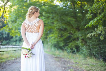 Beautiful bride holding her nice bouquet of flowers.の写真素材