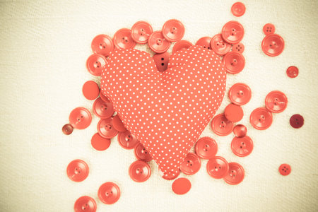 Dotted fabric heart on tiny red buttons.の写真素材