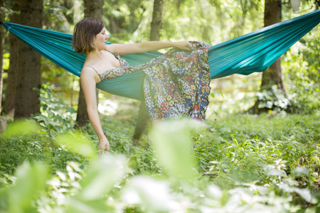 Woman relaxing in nature in a hammockの写真素材