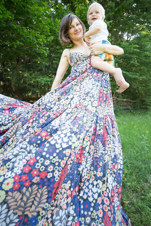 Woman in flowery dress with babyの写真素材