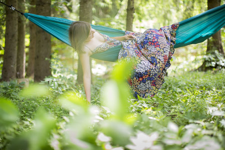 Woman relaxing in nature in a hammockの写真素材