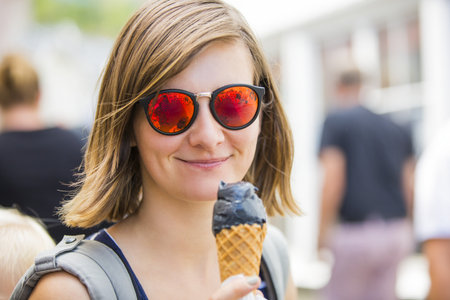 Portrait of woman, eating ice-cream outdoor, Urban and blessing concept.