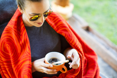 Woman relaxing in nature with a cup of caffeeの写真素材