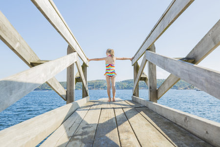 Plank on the water with a blond little girlの写真素材