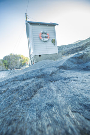 stone surface and a white lifeguard cabinの写真素材