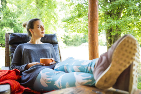 young woman holding a cup of coffeeの写真素材