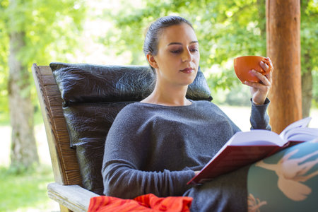 young woman holding a cup of coffeeの写真素材