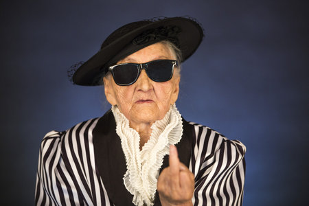 Old grandma in a white-black striped jacket