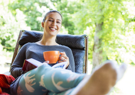 young woman holding a cup of coffeeの写真素材