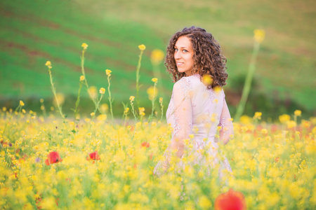 curly haired woman in the poppy meadowの写真素材