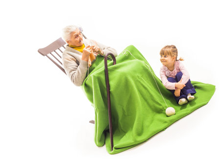 Old woman sitting on the chair with grandchildrenの写真素材