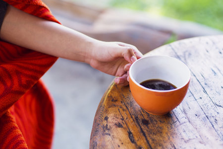 woman hands holding a cup of coffeeの写真素材