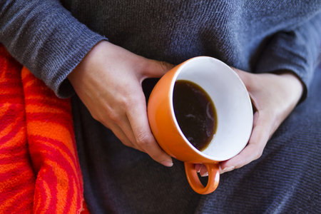 woman hands holding a cup of coffeeの写真素材