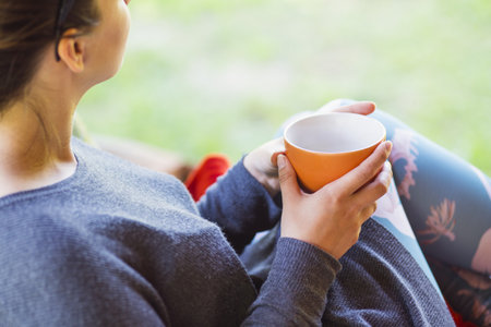 woman hands holding a cup of coffee