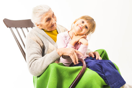 Old woman sitting on the chair with grandchildren