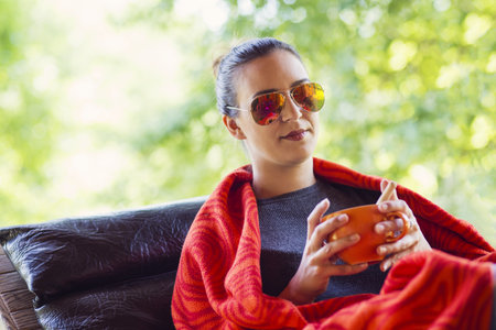 woman hands holding a cup of coffeeの写真素材