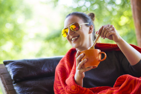 woman hands holding a cup of coffeeの写真素材