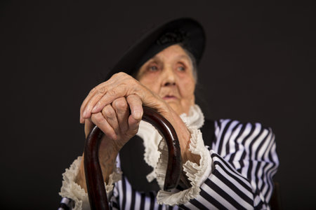 Old grandma in a white-black striped jacketの写真素材