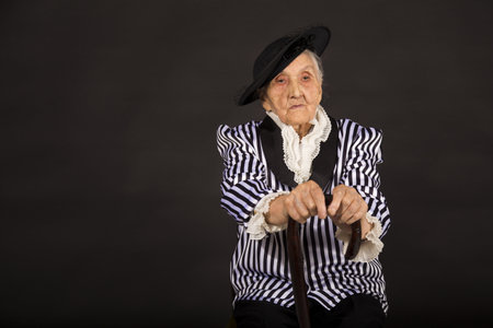 Old grandma in a white-black striped jacketの写真素材