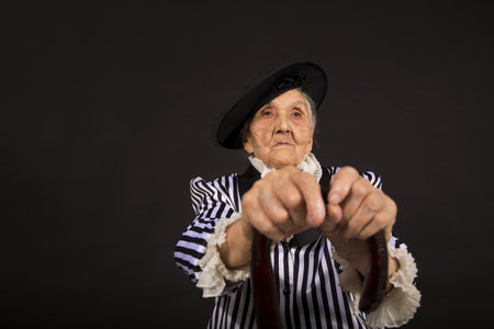 Old grandma in a white-black striped jacketの写真素材