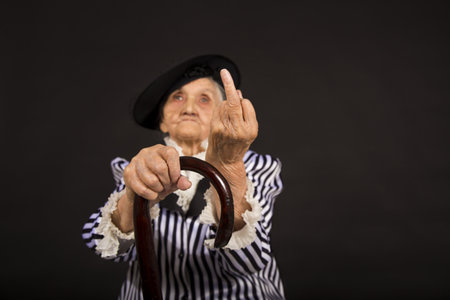 Old grandma in a white-black striped jacketの写真素材