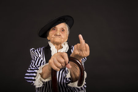 Old grandma in a white-black striped jacketの写真素材