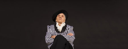 Old grandma in a white-black striped jacketの写真素材