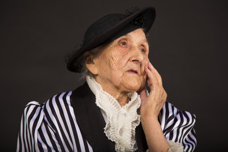 Old grandma in a white-black striped jacketの写真素材
