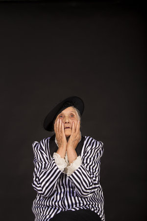Old grandma in a white-black striped jacketの写真素材