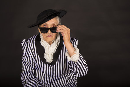 Old grandma in a white-black striped jacketの写真素材