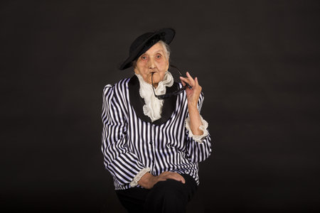 Old grandma in a white-black striped jacketの写真素材
