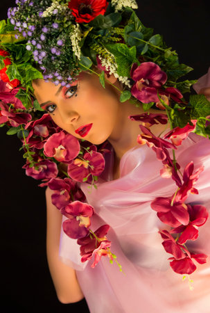young fairy woman with flowers on her headの写真素材