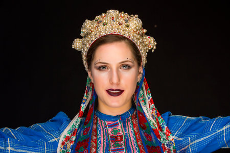 young brunette in folk clothes and pearl corollaの写真素材