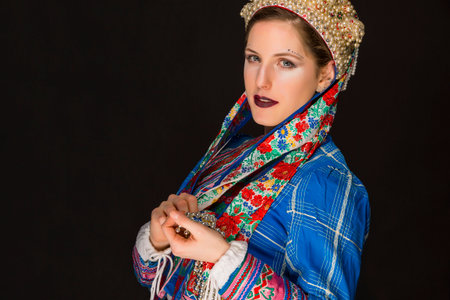 young brunette in folk clothes and pearl corollaの写真素材